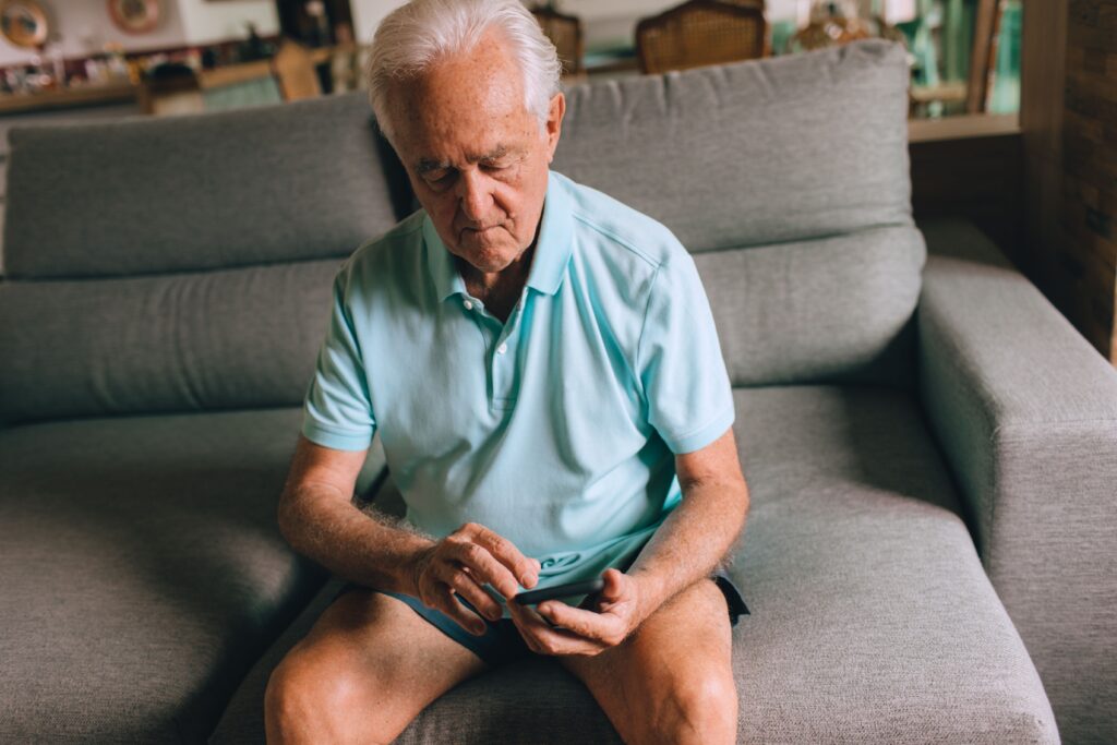 older person looking at cardio app on phone
