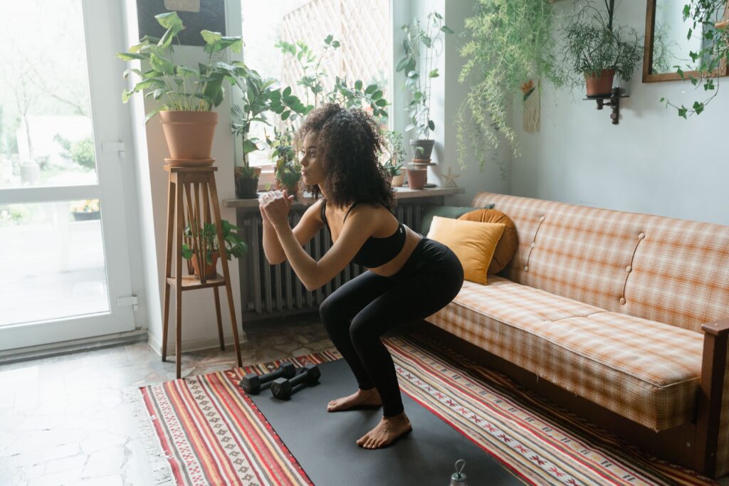 woman doing squats at home