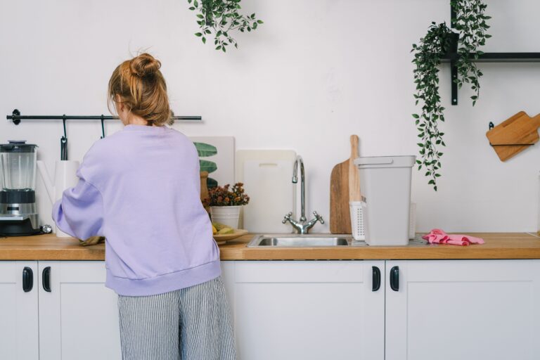 woman cleaning kitchen counter