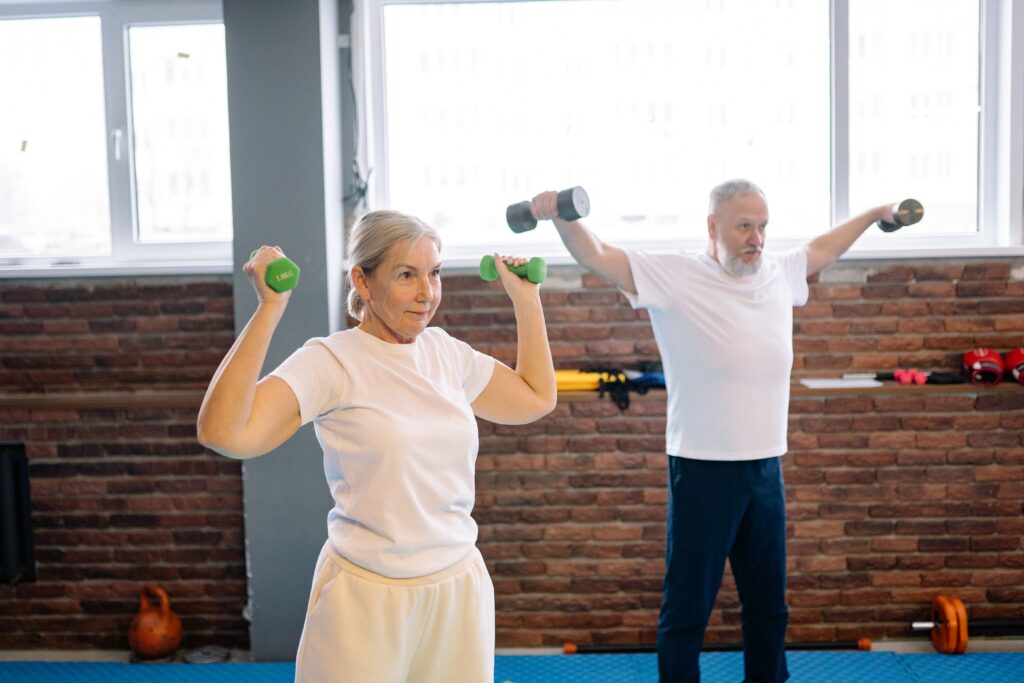 older persons lifting weights at home