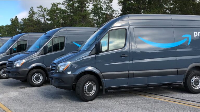 A row of Amazon Prime branded delivery vans