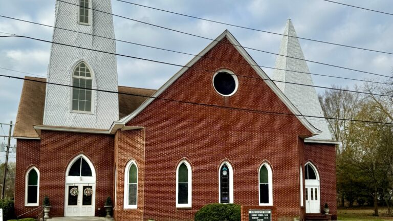 A red-brick Baptist church exterior, a generic American church building not the specific congregation named in the article
