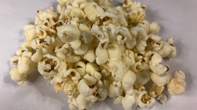 A pile of cheddar popcorn, representative of the snack category affected by the recall