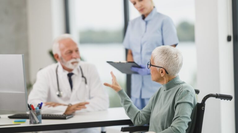 A doctor and patient in conversation at a medical office desk
