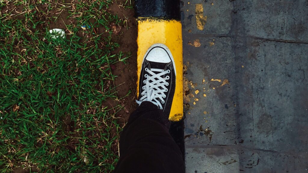 person stepping on yellow surface