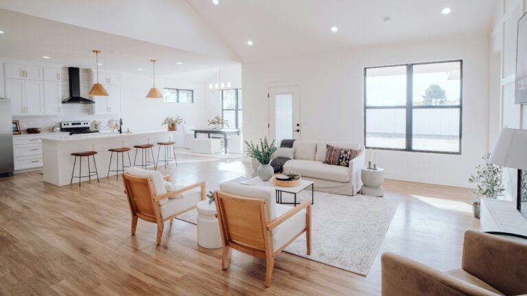 a living room filled with furniture and a kitchen