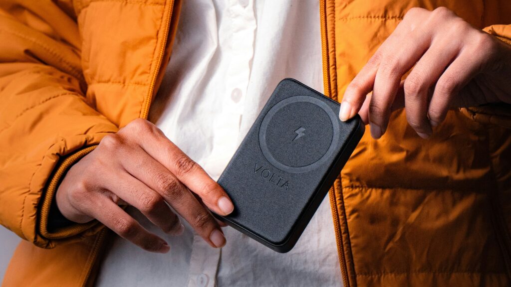 a person holding a cell phone in their hand