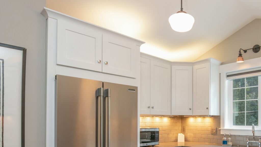 white wooden kitchen cabinet and white pendant lamp
