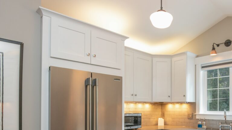 white wooden kitchen cabinet and white pendant lamp