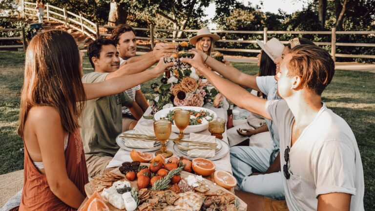 people sitting on chair eating food during daytime