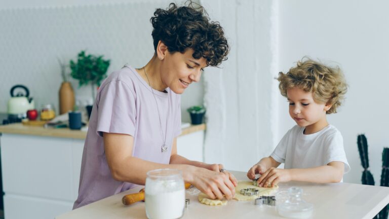 a woman and a child are making cookies