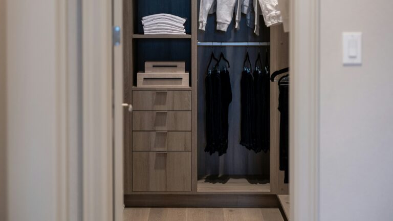 A modern walk-in closet with organized clothing and shelves