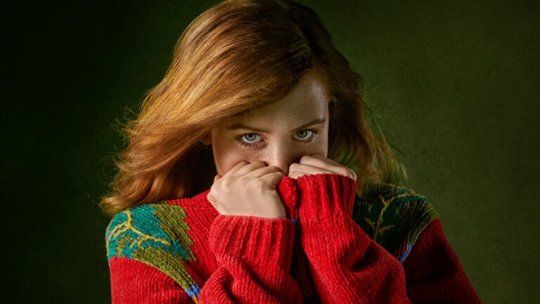 woman covering mouth with sweater