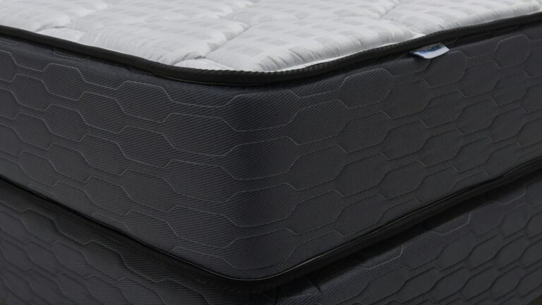 Close-up of a modern mattress with a dark patterned base