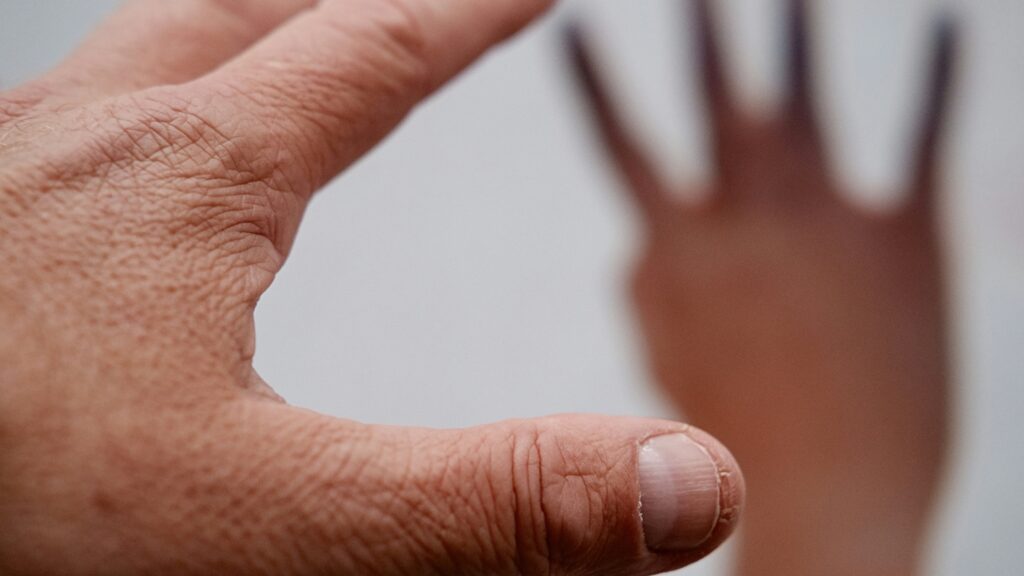 persons left hand on white surface