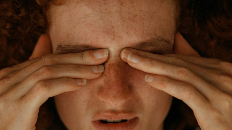 a woman with red hair covering her eyes