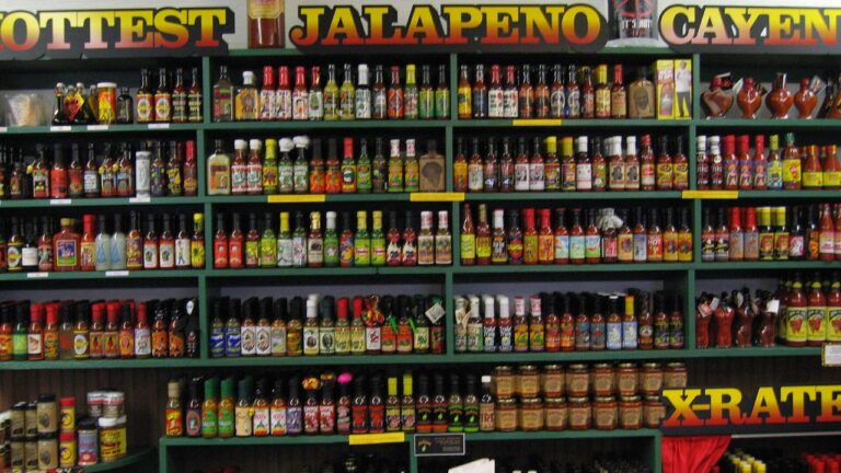 Hot sauce bottles on a shelf — Image Credit: Tom Harpel - CC BY 2.0/Wiki Commons