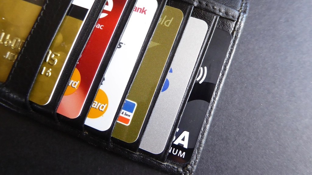 A wallet open showing several credit and debit cards