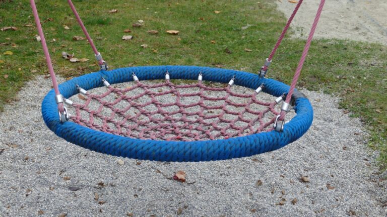 Close-up of a playground swing seat strap and carabiner hardware