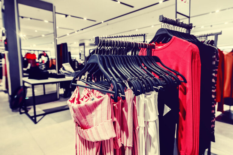 Women's clothes on racks in a fashion retail store