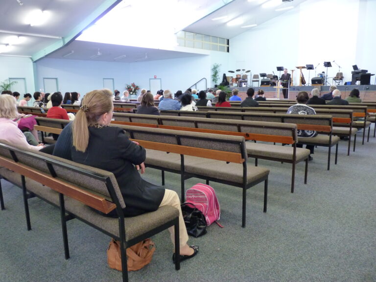 A congregation seated in pews during a service