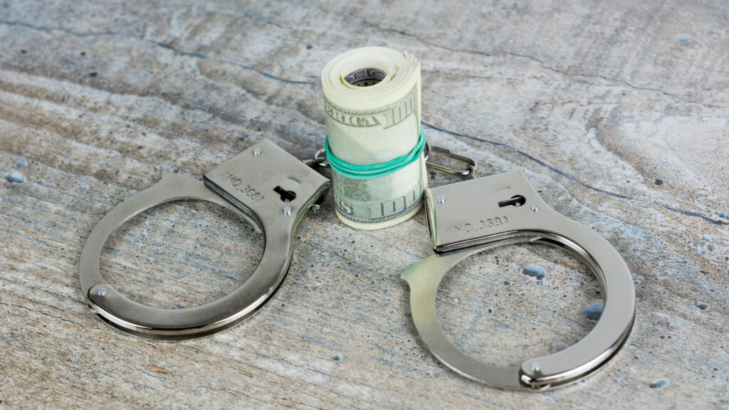 a pair of scissors and a roll of money on a table