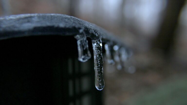 water droplets on black metal bar