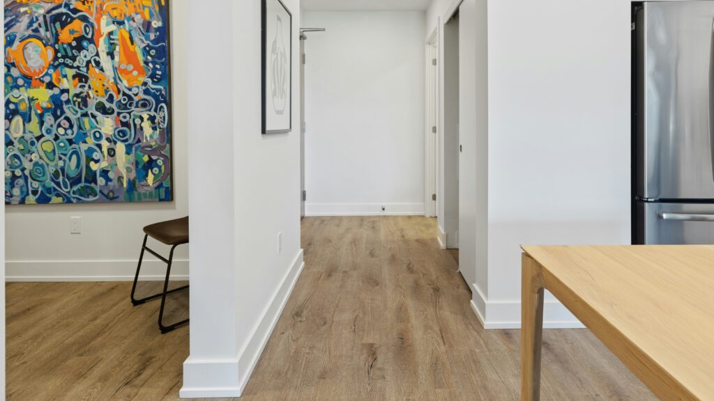 brown wooden table near white wall