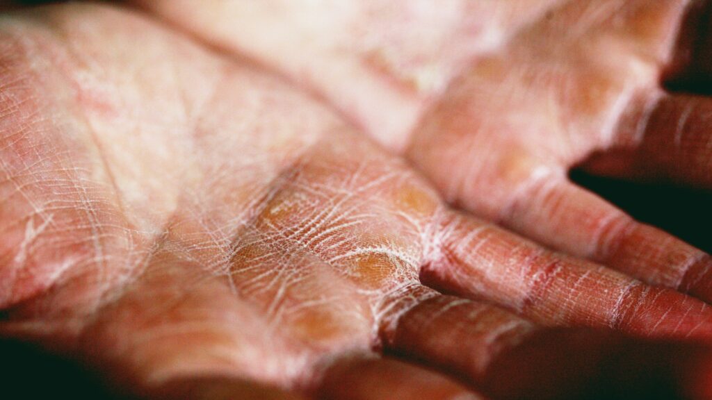 person holding brown and white textile