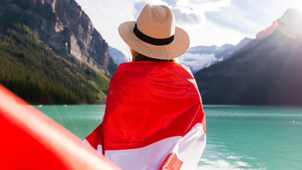 a person wearing a hat and a red and white blanket on a boat