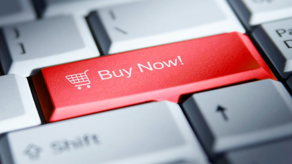 Red 'buy now!' button on a computer keyboard