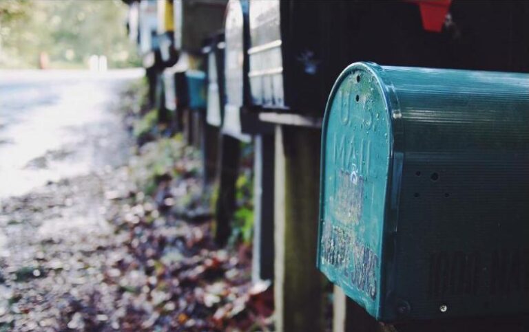 A row of outdoor mailboxes along a residential street