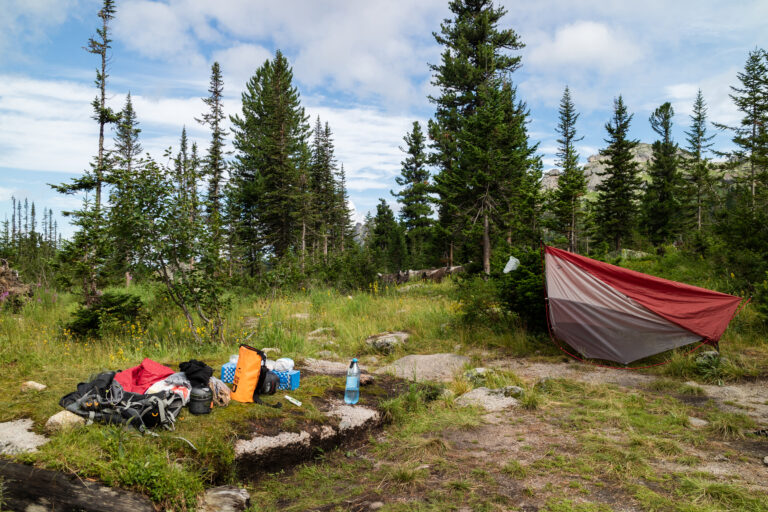 Outdoor camping gear laid out at a campsite, representing the recalled camping shower product category