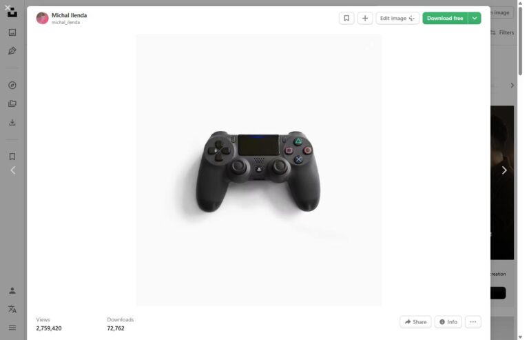 A black video game controller on a plain background