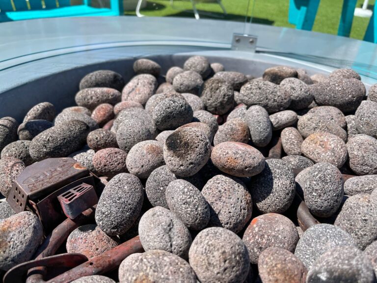 Close-up of decorative lava rocks used in a backyard propane fireplace insert