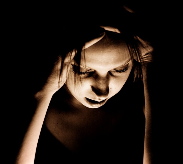 Woman holding her head in pain